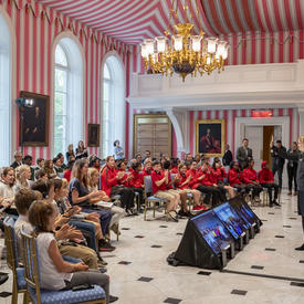 Over one hundred students and teachers sit and face the Governor General in the Tent Room of Rideau Hall as they engage in a question and answer session.