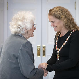 The Governor General shakes hands with a recipient during an Order of Canada ceremony.