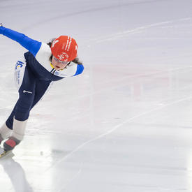 A speed skater takes a tight turn during a race at the Special Olympics.