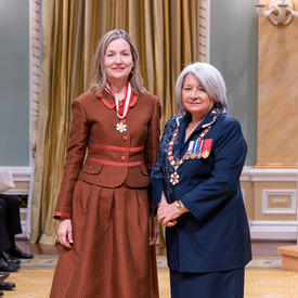 Marcia Vaune Jocelyn Kran is standing next to the Governor General.