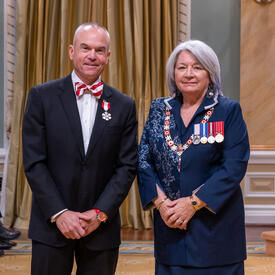 L. David Dubé is standing next to the Governor General.