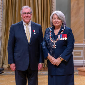 William John Fox is standing next to the Governor General.