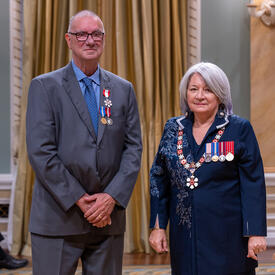 Peter Harrison is standing next to the Governor General.