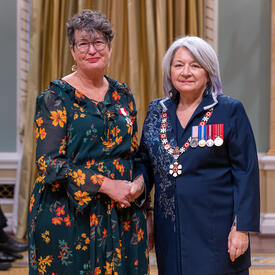 Michele M. Leering is standing next to the Governor General.