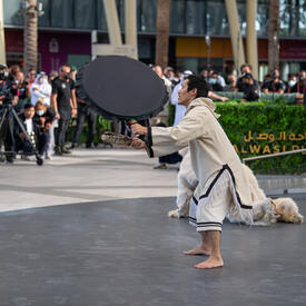 A man is performing before a crowd at Expo 2020 Dubai.