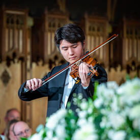 A man is playing a violin during the service.