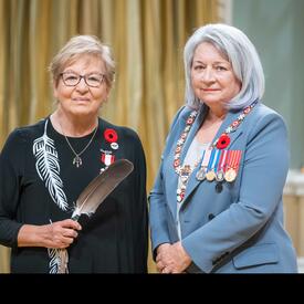 Elder Carolyn F. King is standing next to the Governor General.