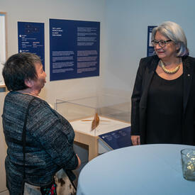 La gouverneure générale s'entretient avec une femme lors de l'exposition Notre territoire, notre art.