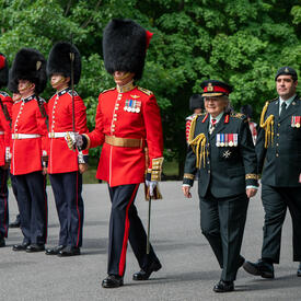 Governor General Mary Simon salutes the Commander of the Ceremonial Guard. She is wearing a Canadian Armed Forces army uniform.