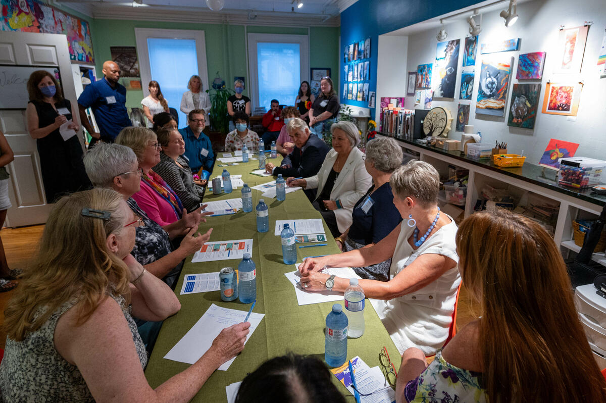 Governor General Mary Simon sits and talks to youth attending an art activity at Laing House