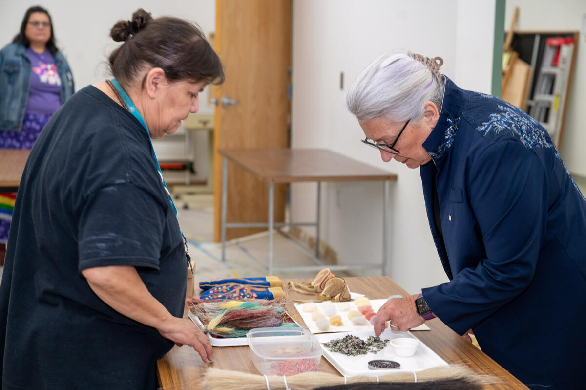 La gouverneure générale Mary Simon examine de petits objets sur une table