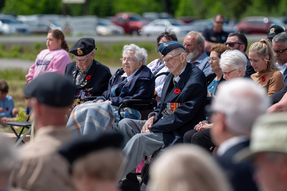 Veterans attending the ceremony sit and listen in the gathered crowd