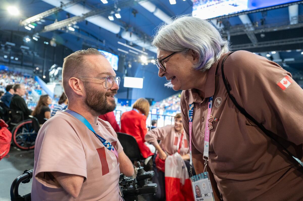 The Governor General of Canada Mary Simon is talking to a Team Canada athlete in a motorized chair.