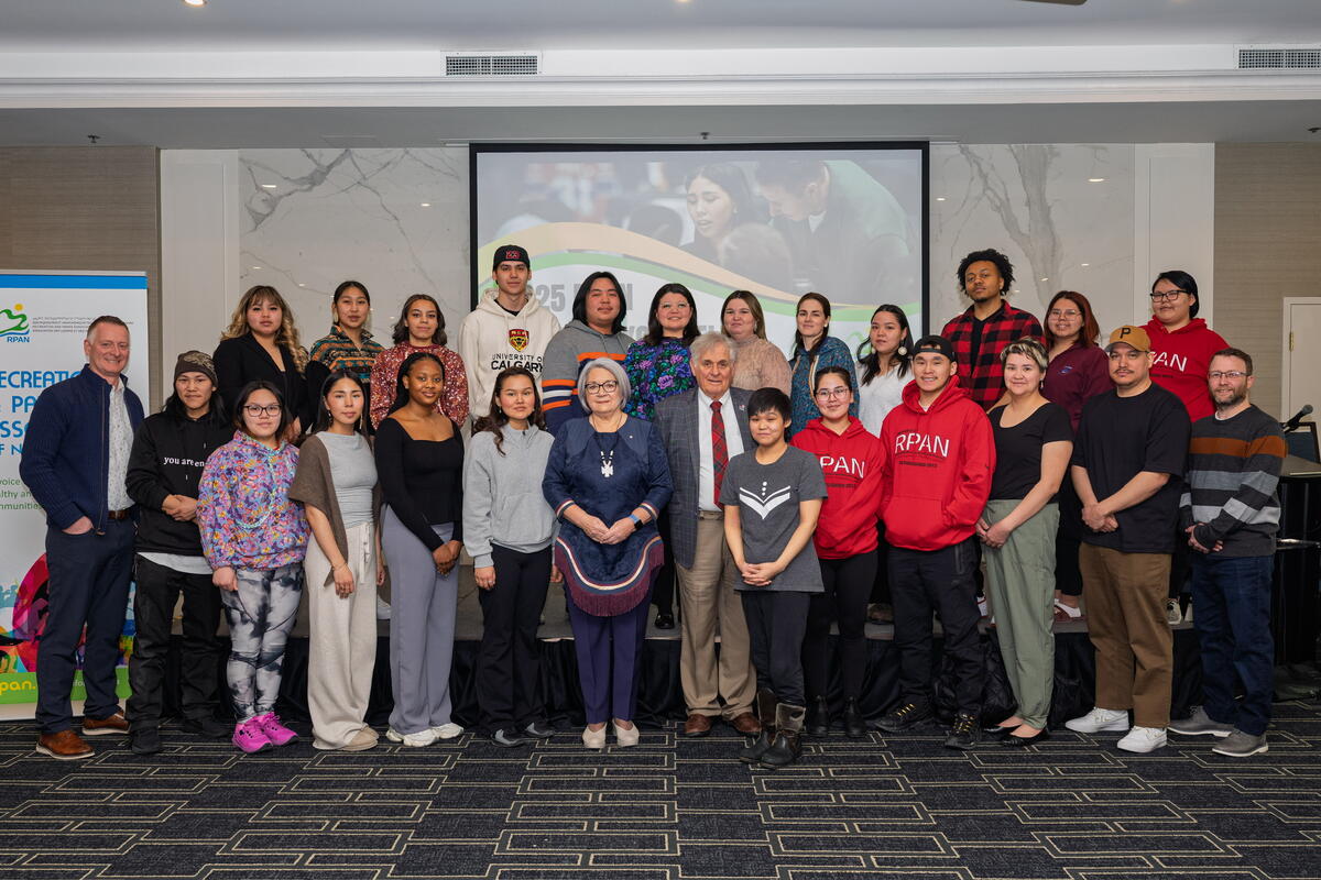 A group posing for a photo with Governor General Mary Simon and Mr. Whit Fraser.