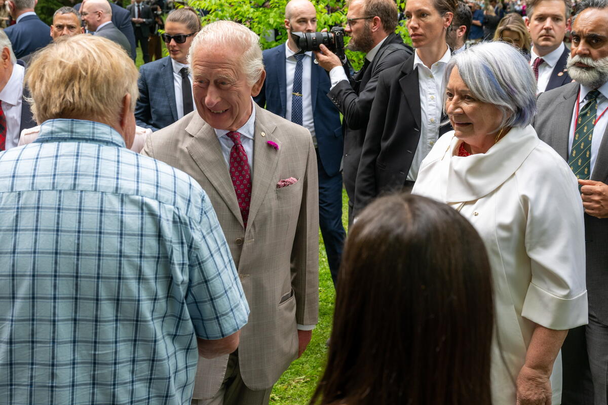 His Majesty King Charles III shaking hands with people outside of Rideau Hall.