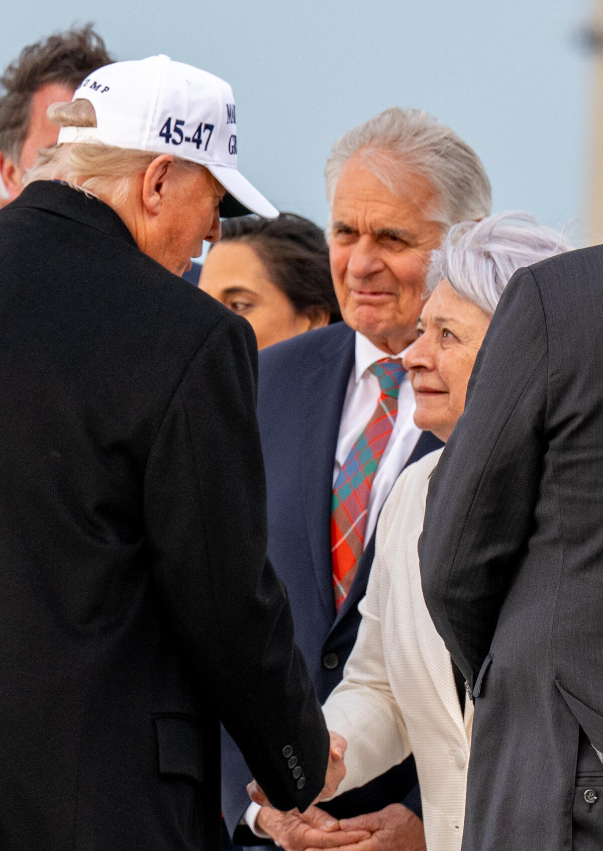 Governor General Mary Simon shaking hands with President Donald Trump at the airport.
