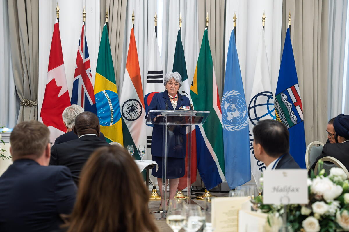 Governor General Mary Simon standing at a podium at a G7 event.