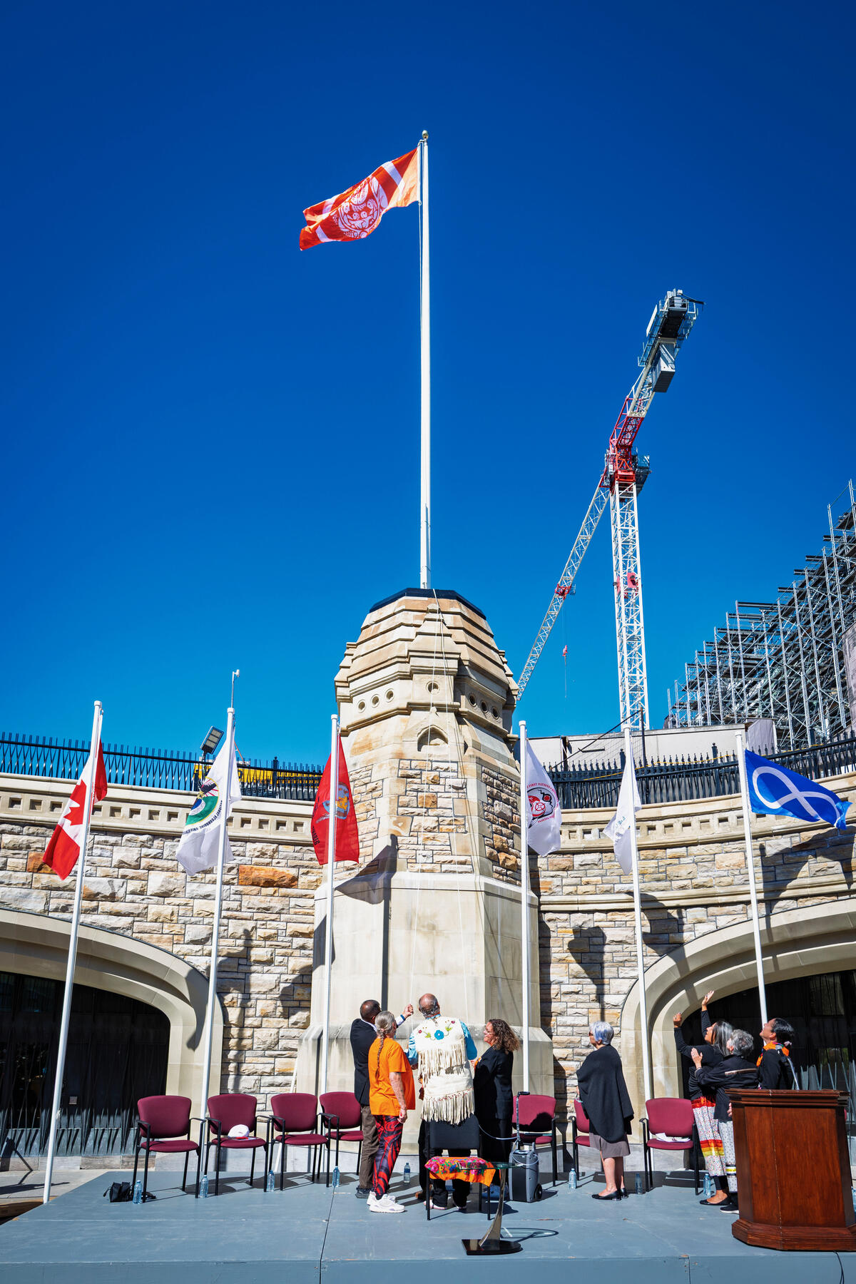 Flag raising outside of Parliament.