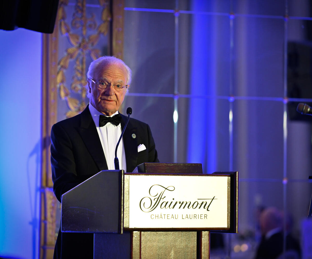 His Majesty King Carl XVI Gustaf of Sweden standing at a podium.