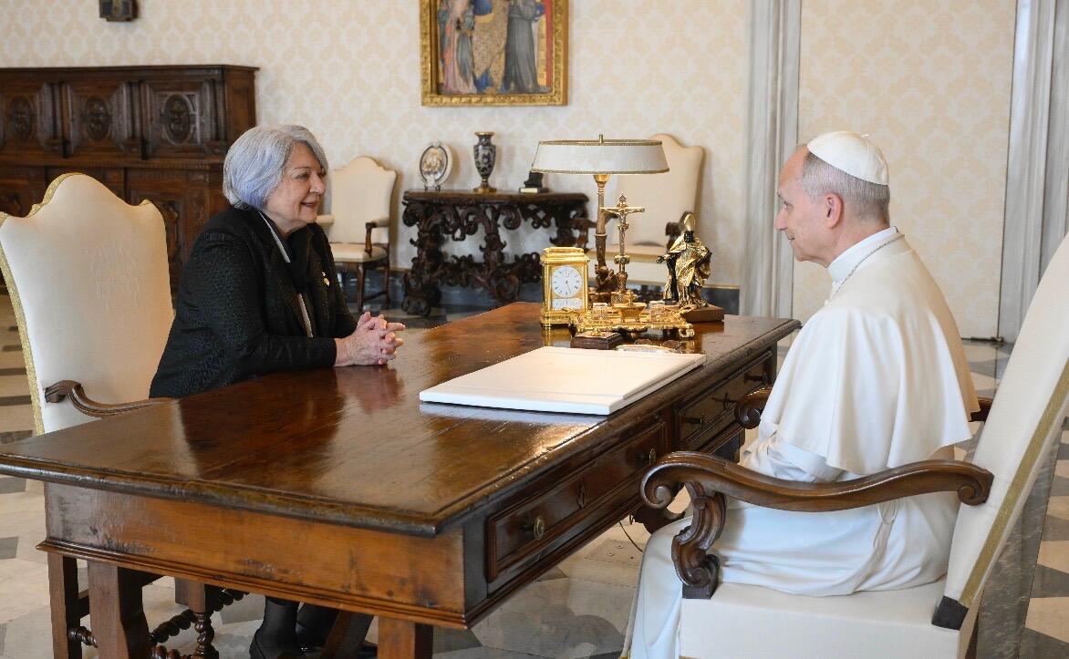 Governor General Mary Simon seated across from His Holiness Pop Leo XIV at a large wooden table.