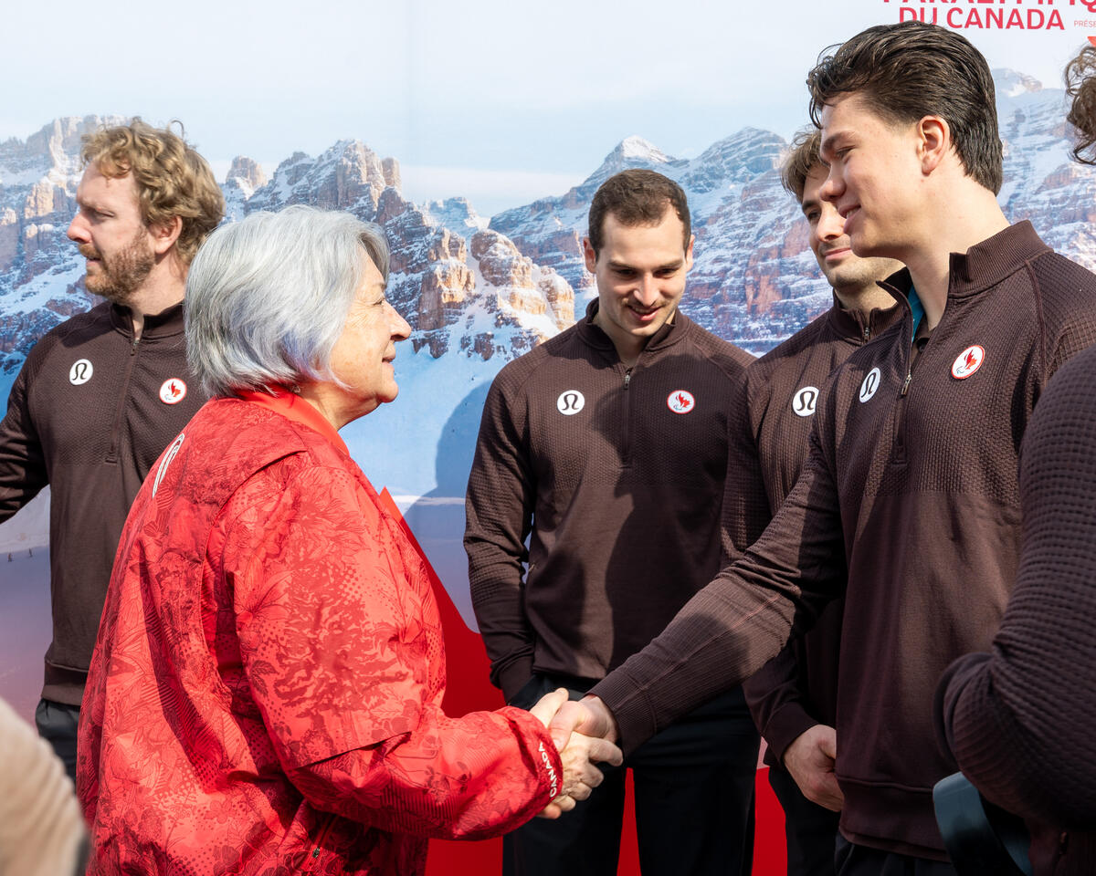 Governor General Mary Simon shaking hands with one of the Paralympic athletes.