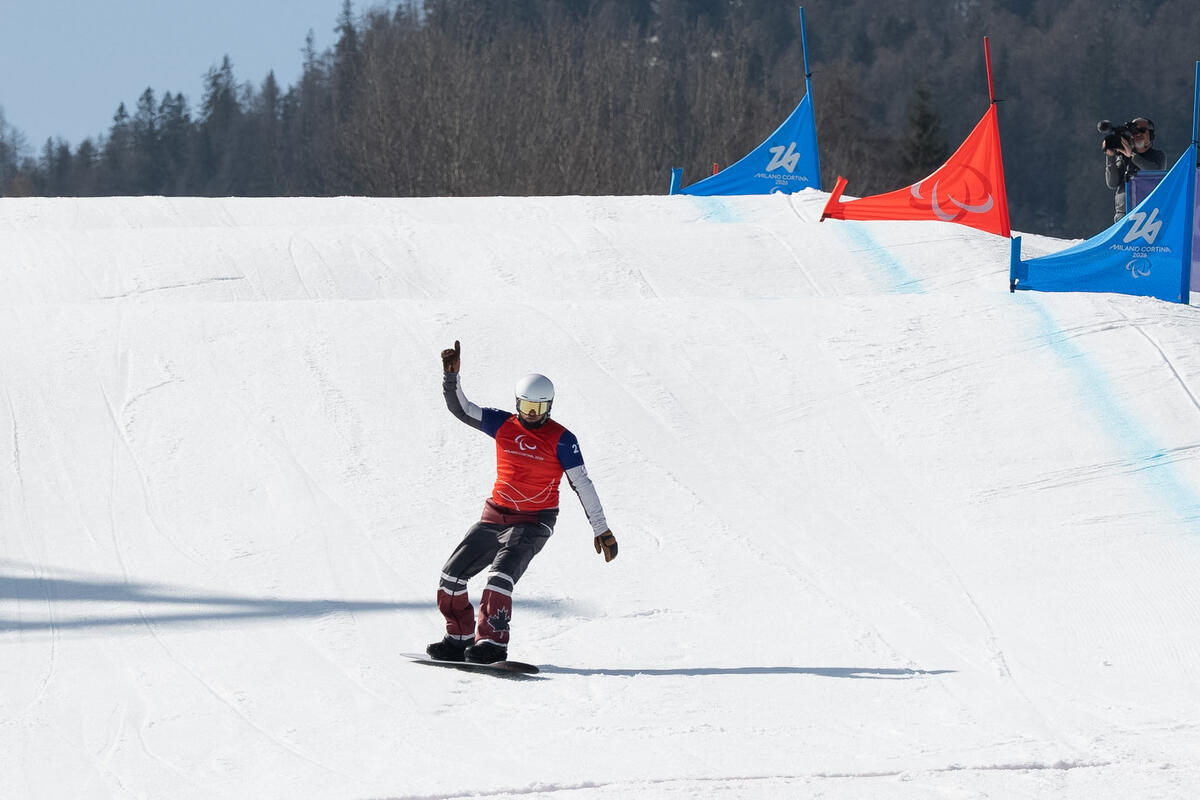 An athlete competing in para snowboarding. 