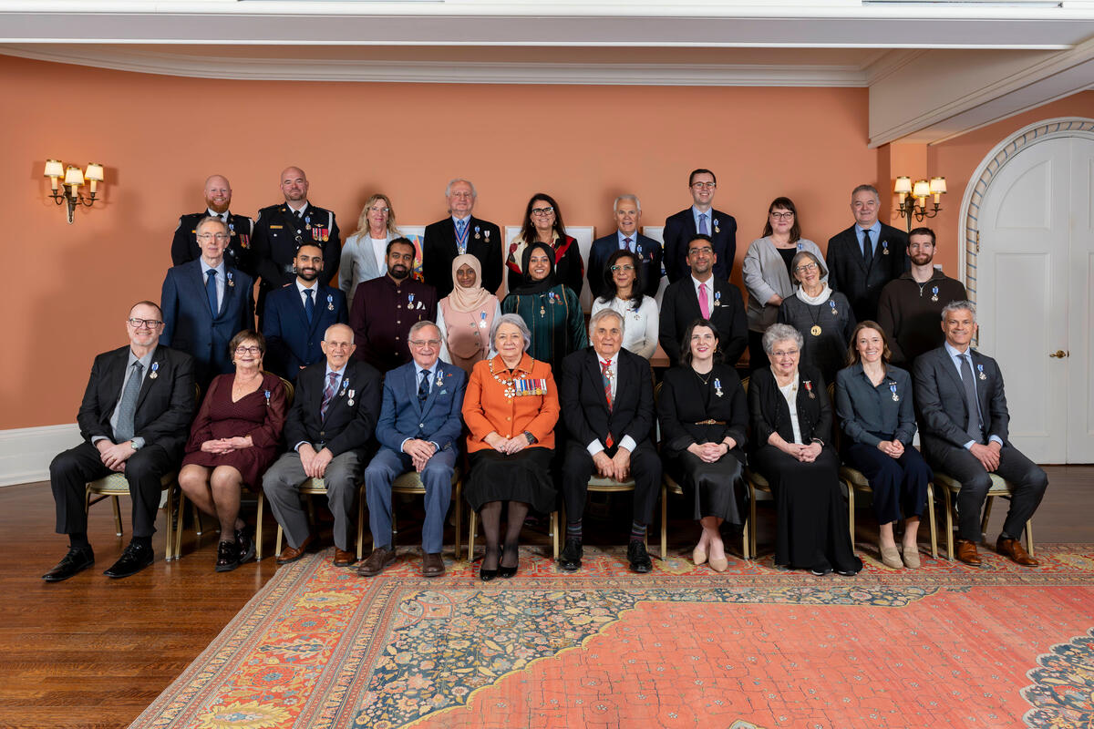 Governor General Mary Simon and Mr. Whit Fraser posing with Honours recipients.