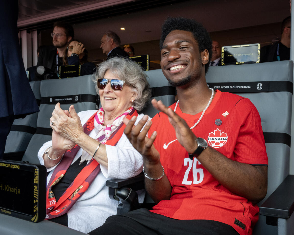 Governor General Arbour and her guest, a student from Louise Arbour Secondary School, cheering at the FIFA match.