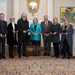 A group of people poses for the camera. Governor General Mary Simon and Mr. Whit Fraser are in the centre.