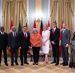 Une photo de groupe avec la gouverneure générale Simon et avec sept nouveaux chefs de mission. Les drapeaux de chaque pays se trouvent derrière eux.