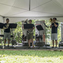 Five young musicians ply their brass instruments on the grounds of Rideau Hall.