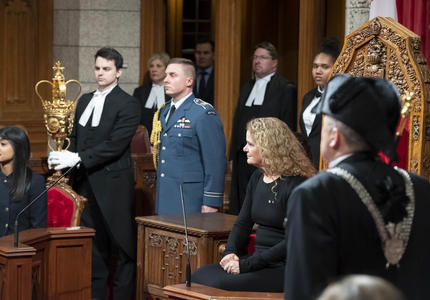 The Governor General sits in the Senate Chamber.
