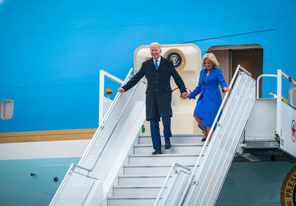 President Joe Biden and First Lady Jill Biden exit the airplane and walk down stairs.