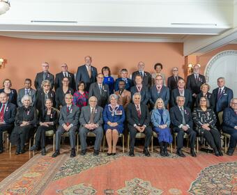 Governor General Mary Simon posing with Order of Canada recipients.