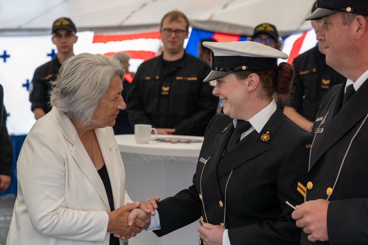 Governor General Mary Simon shakes hands with a member of the Royal Canadian Navy.