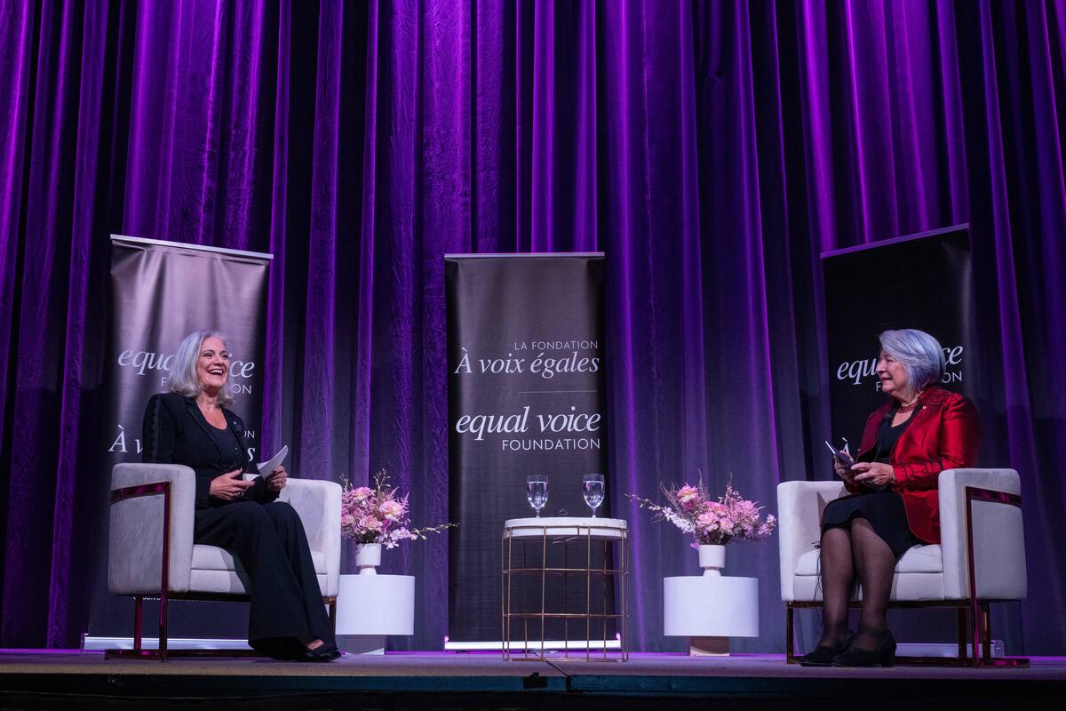 Governor General Mary Simon sits on a stage talking to Lisa LaFlamme