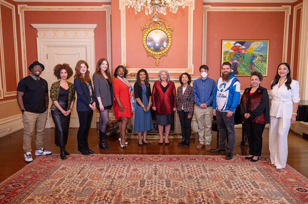 Governor General Mary Simon stands with the symposium panelists in the Large Drawing Room